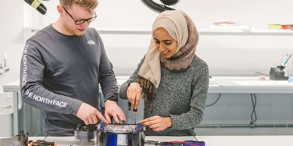 Two students at the Dyson Institute working on a practical project