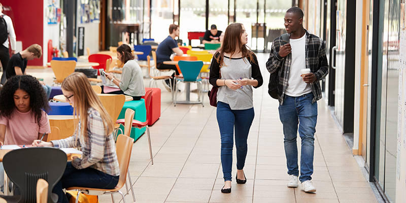 young students walking through a sixth form school